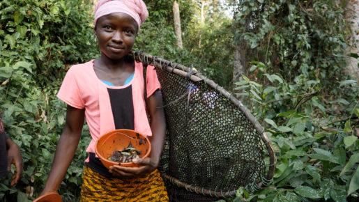 A member of the Sama Village Women's Association demonstrating her fishing haul.